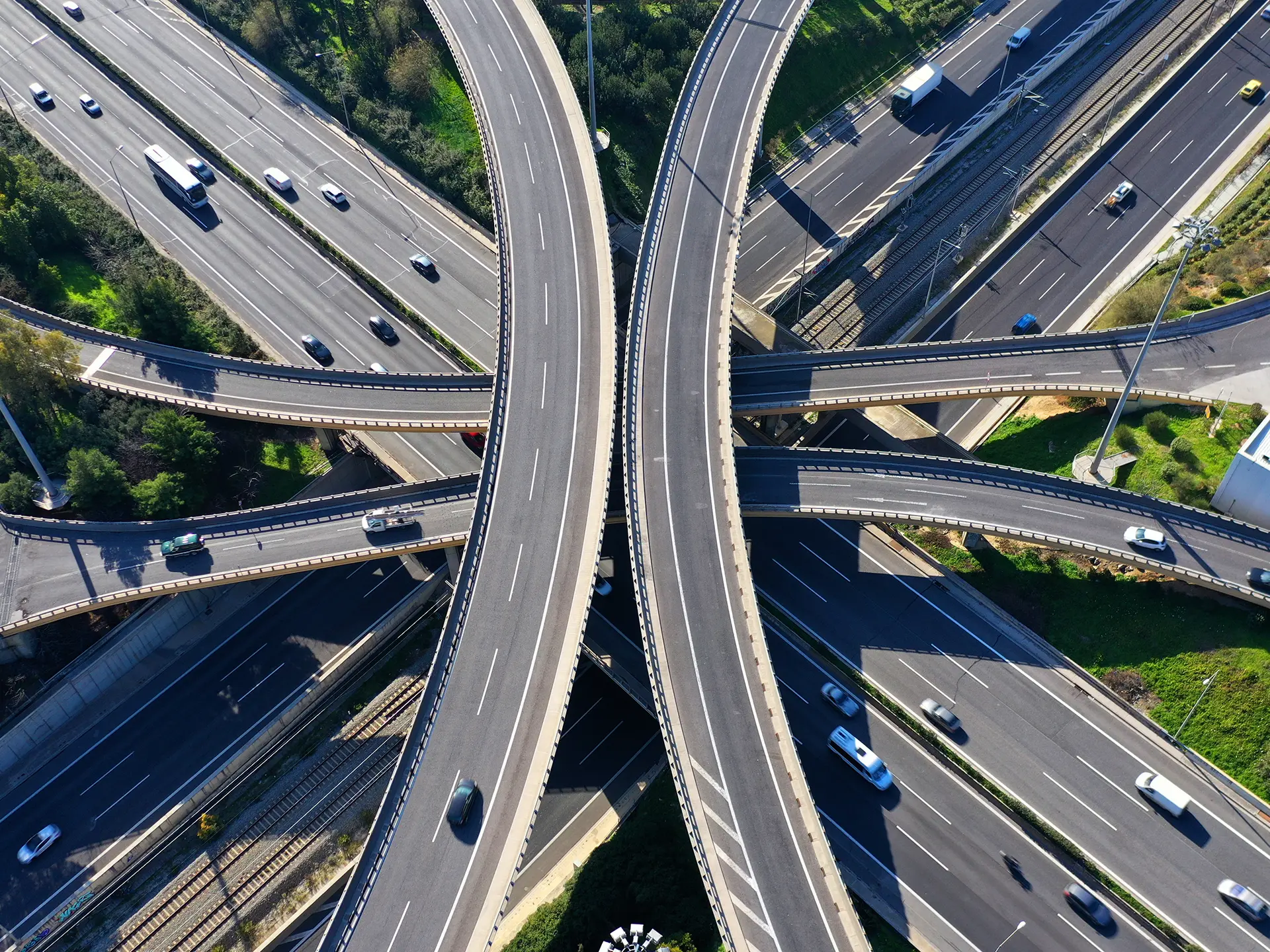 Aerial view of intersecting elevated highways with vehicles traveling along multiple lanes and overpasses.
